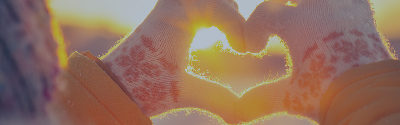 Hands creating a heart shape with sunlight in background 2