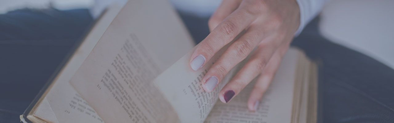 Woman's hand turning a page in a book
